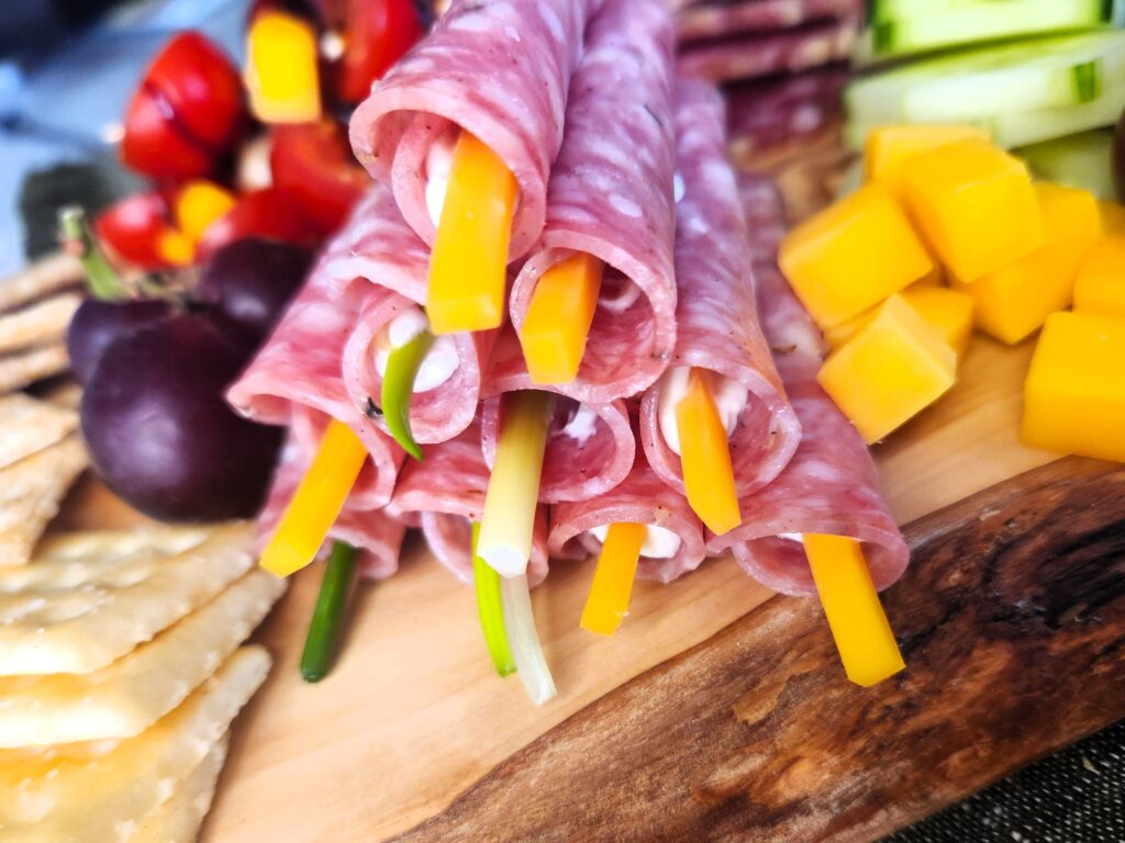 Cream Cheese Salami Rollups featured on our Kick'n Kitchen's Ultimate Charcuterie Board