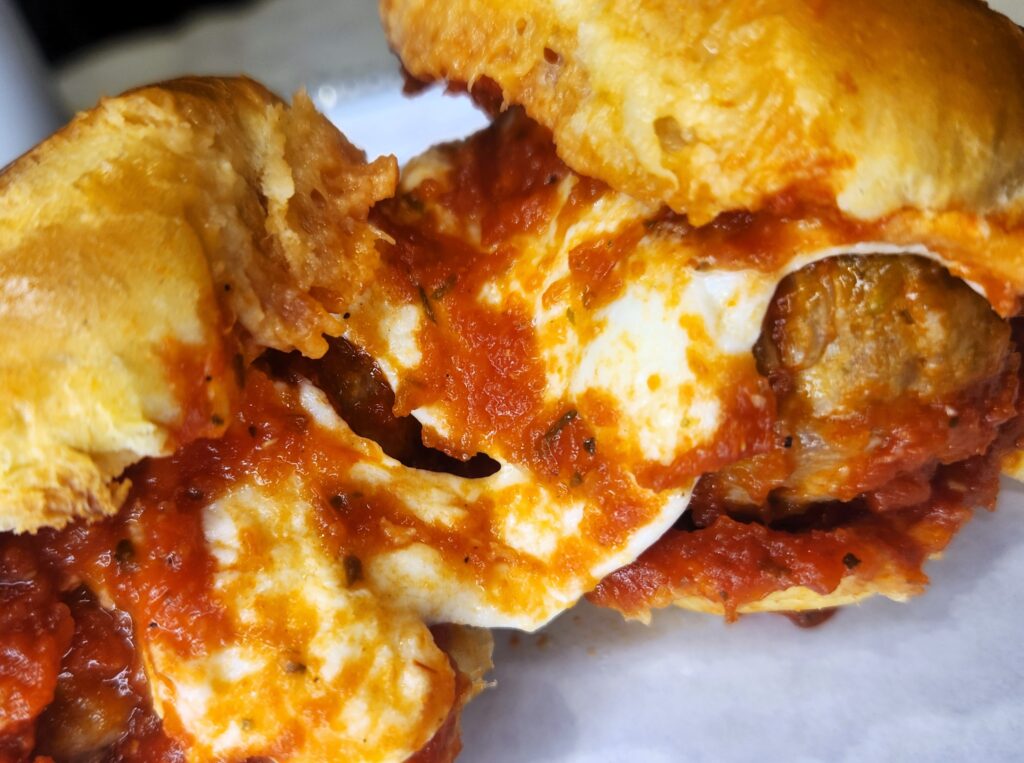 Awesome Meatball Sliders with delicious melted mozzarella cheese pull.