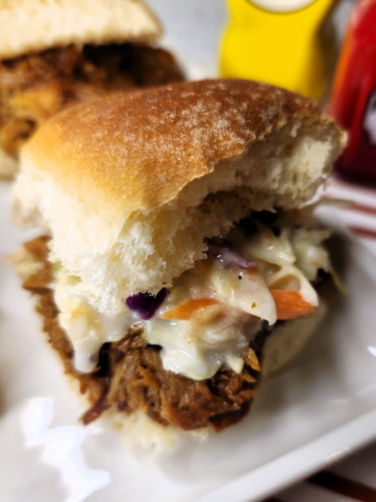 Easy BBQ Pulled Pork Sliders close up to see the tasty pulled pork and our Super Easy Coleslaw.