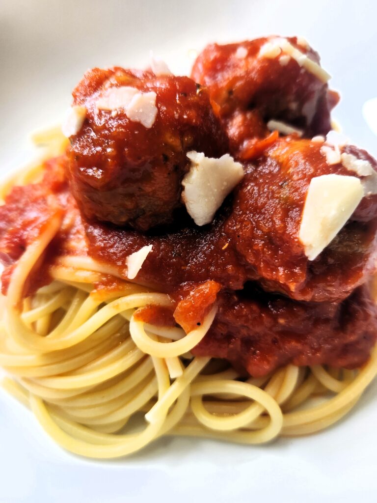 Perfect Turkey Meatballs served atop a pile of spaghetti noodles.