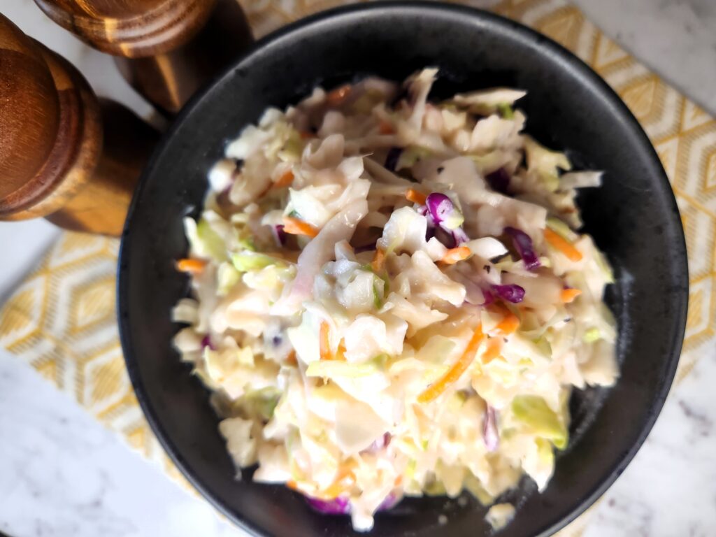 Our Super Easy Coleslaw ready to be served with your favorite sandwich or just as a side to some Fried Chicken Strips.