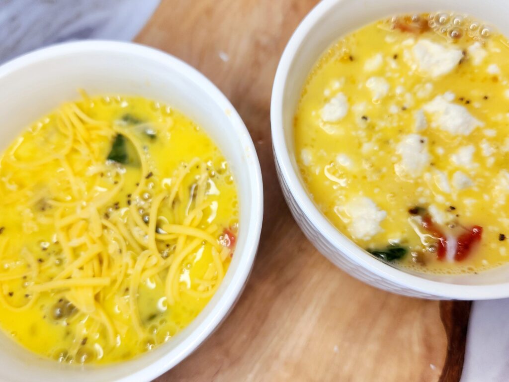 Pour whisked eggs into individual dishes for Personalized Mini Frittatas