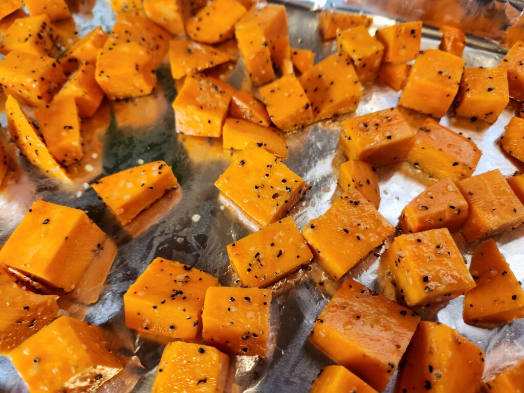 Seasoned sweet potatoes ready for the oven