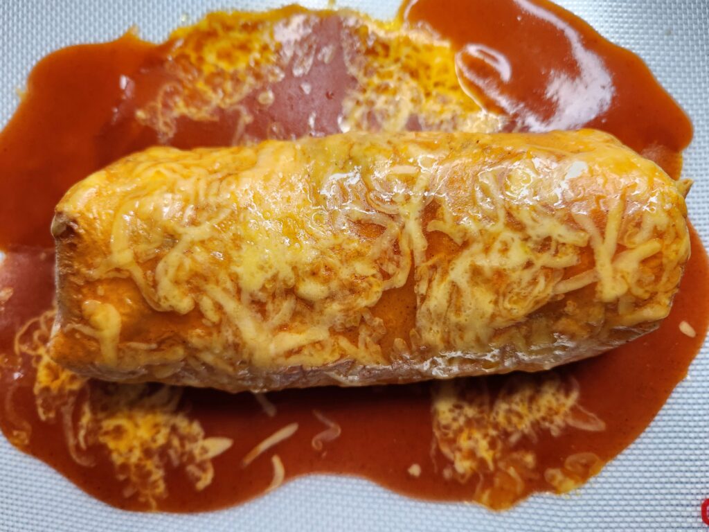 Pour enchilada sauce on top of burrito, sprinkle cheese and place in oven, Smothered Chunky Beef Burritos